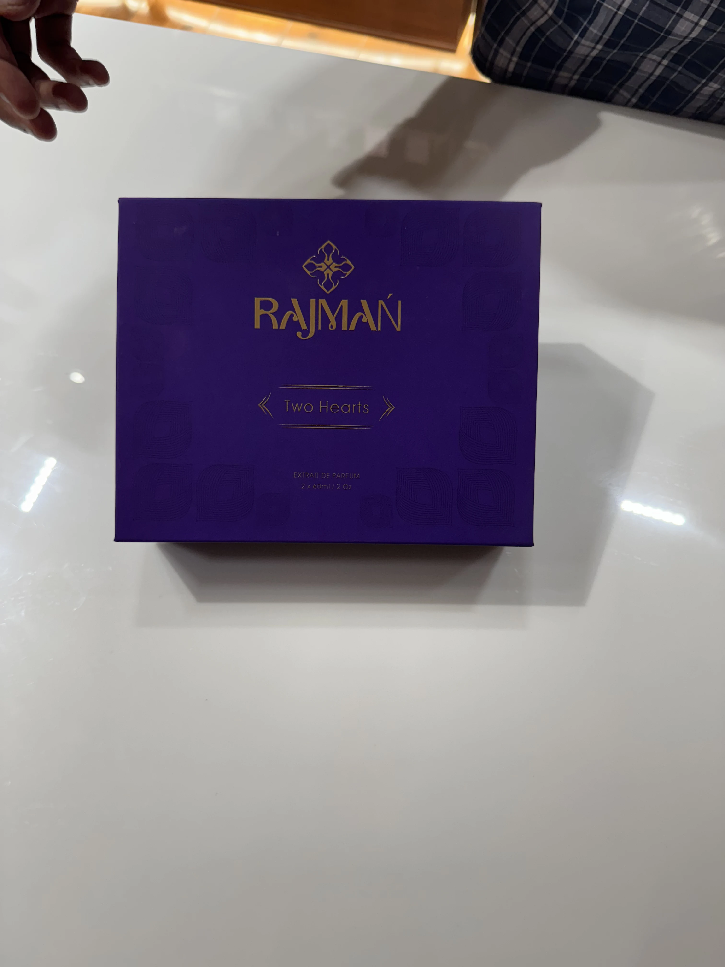 Intricate blind-embossed mandala textures and gold hot-foil debossed typography on royal purple rigid box